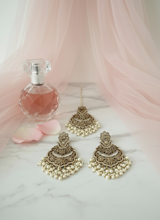 Gold and white pearl jewellery set on marble background