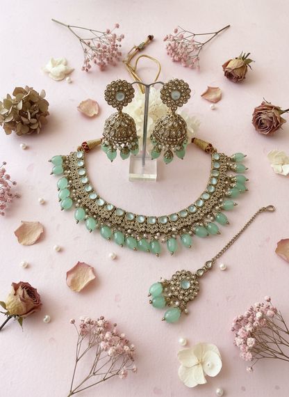 Jewellery set with pastel pink background, dried flowers, rose petals and pearls