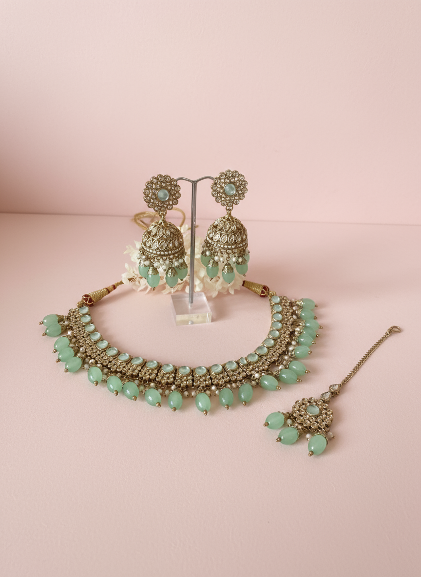 Jewellery set with pastel pink background