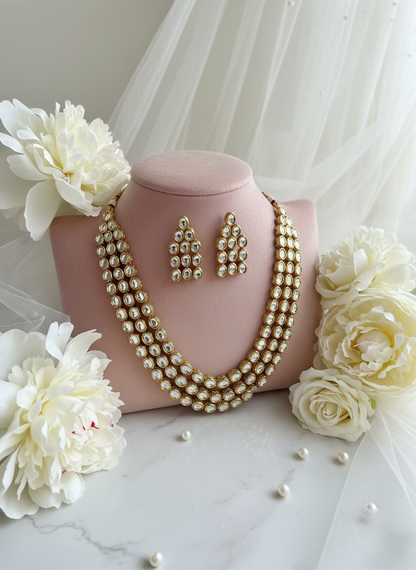 Kundan jewelry on blush velvet with peonies