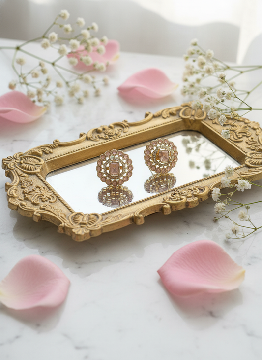 Pink earrings on baroque tray