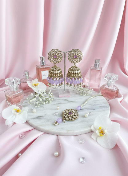 Purple kundan jewelry with pastel pink marble vanity setup