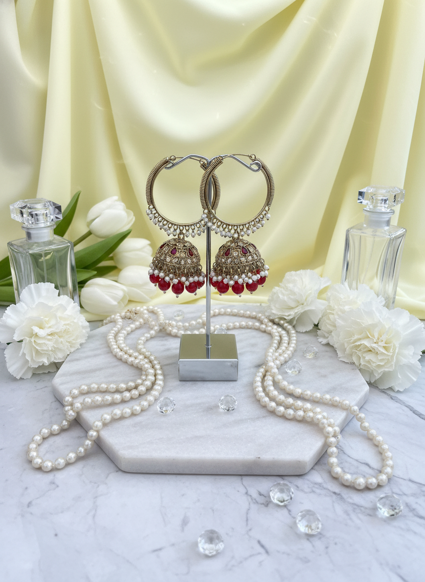 Red kundan bali earrings on pastel yellow