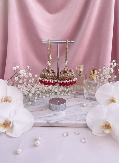 Red kundan bali earrings with orchids on velvet