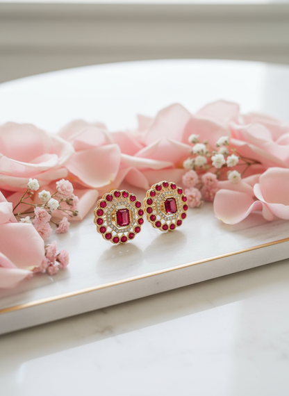 Ruby and gold studs on luxury jewelry tray