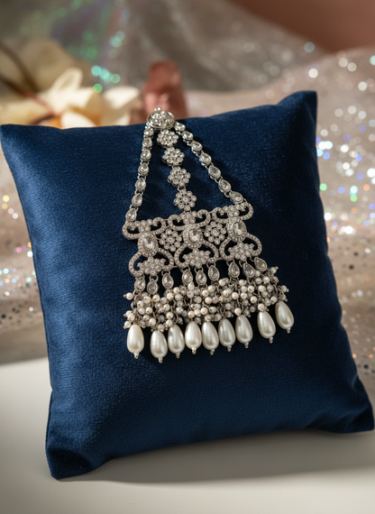 Silver maang tikka on velvet cushion
