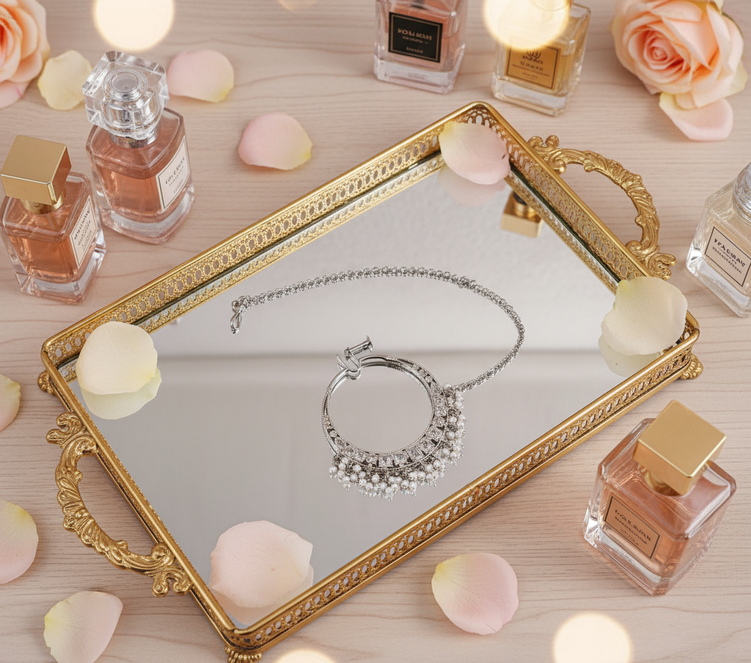 Silver nose ring flat on golden tray with perfumes and rose petals