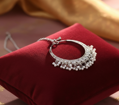 Silver nose ring on cushion